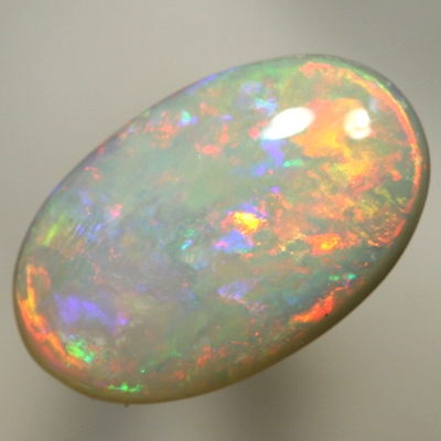 SOLID SEMI BLACK OPAL Bright fire of reds to green to pinky purple. SEE VIDEO